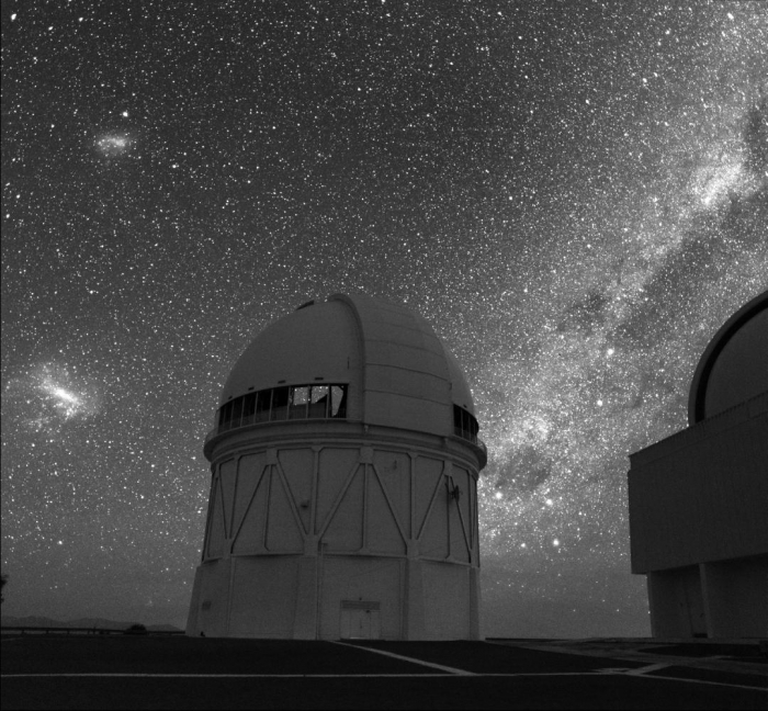Southern sky over Chile with the LMC and SMC visible with an observatory in the foreground